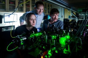 Dirk Englund says the next chapter in the history of technology is not simply about faster computers. He is shown (center) with grad students Sara Mouradian and Marco Schukraft. Photo: Len Rubenstein