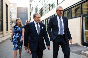 On a visit to MIT, Miguel Alemán Velasco (center), followed by daughters Claudia (in blue) and Monica, walks with AeroAstro faculty member Jaime Peraire. photo: Jake Belcher