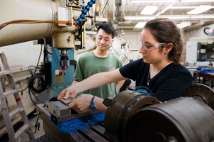 Two students work in an MIT makerspace