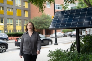 Noelle Selin walks down a city street.