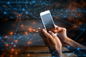 A pair of hands use a mobile phone. The background of the image illustrates connections.