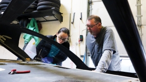 Pat McAtamney discusses front suspension with a student on the Solar Electric Vehicle Team.