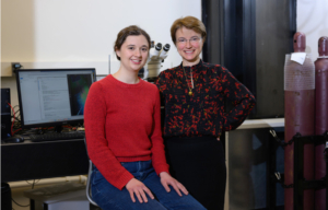 An MIT graduate student and her advisor smile together for a photo in their lab.