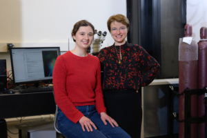 An MIT graduate student and her advisor smile together for a photo in their lab.