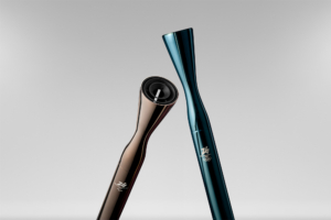 Two sleek metallic cylindrical torches, each with a flare at the end. One is gray and one is teal.