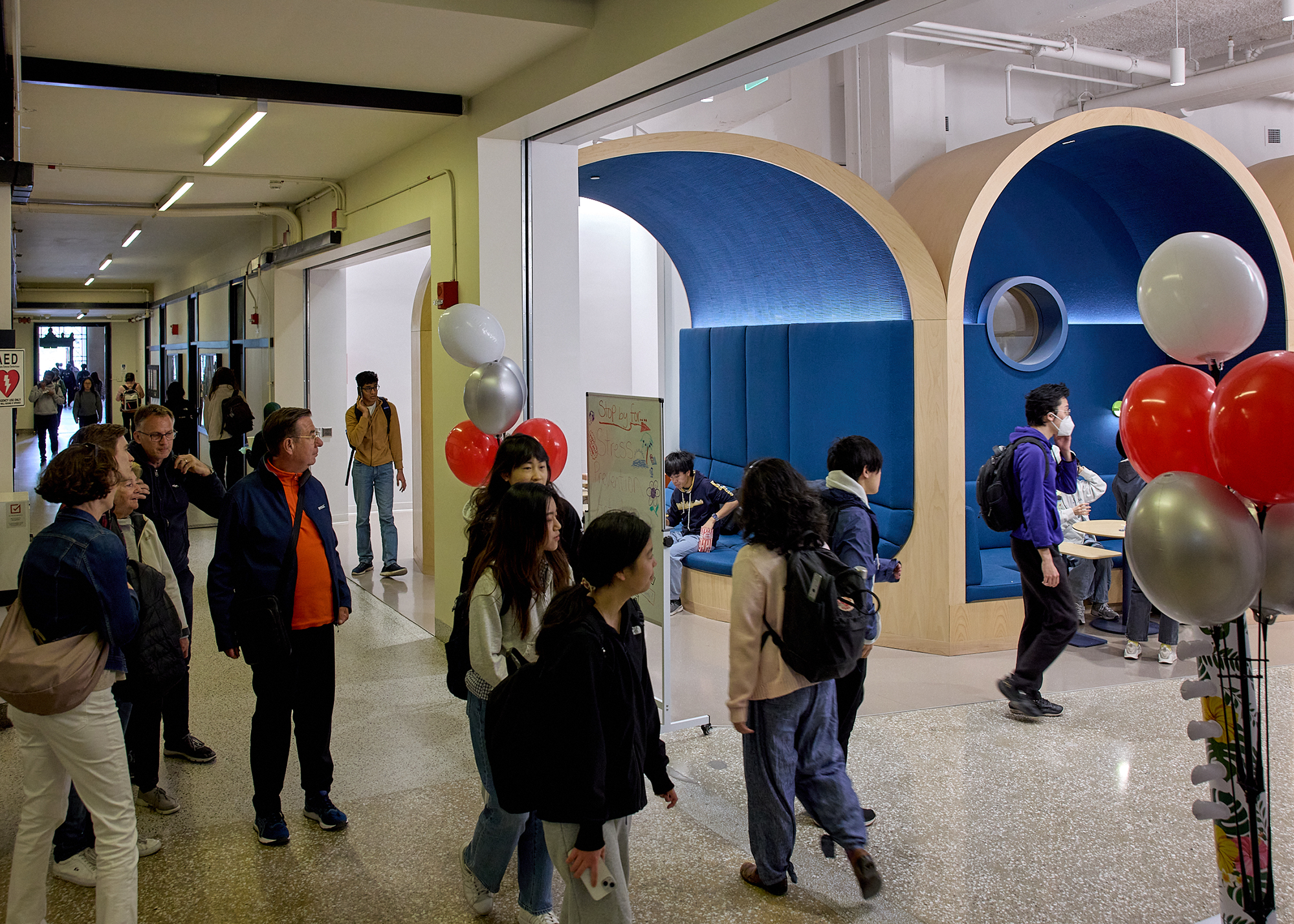 Students and other members of the community walk past and enter the Undergraduate Advising Center from the Infinite Corridor.