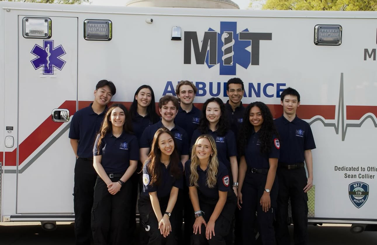 #nivoslider-slxLa-32838-caption-1 Elizabeth Romero poses with other volunteer EMTs in front of their ambulance.